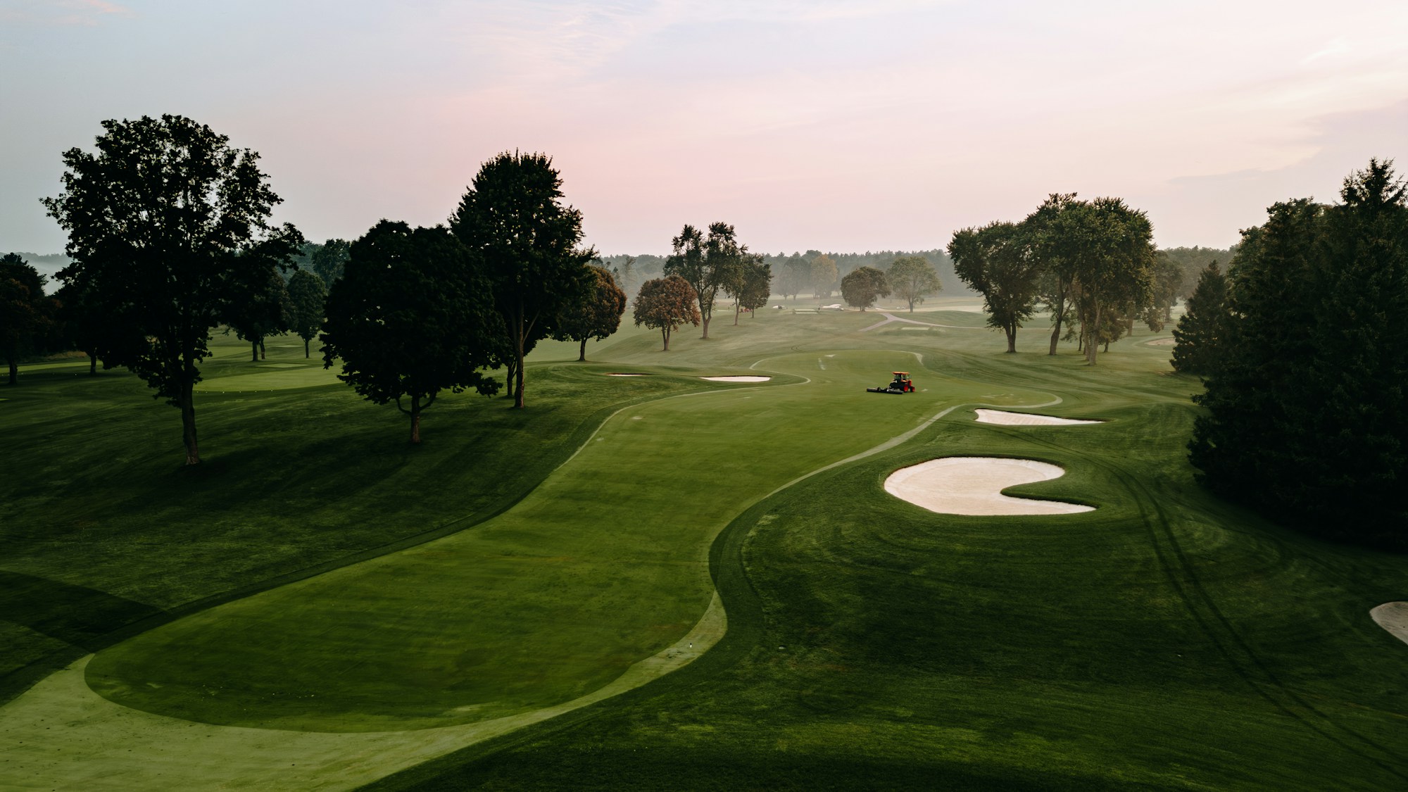 Morning mist over tree-lined fairways